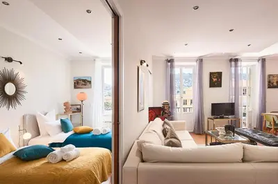 a living room with a bed and a couch in a room at Sunlight Properties - Marinette - Port area, 2 Bedrooms, sleep 6, sea view in Nice