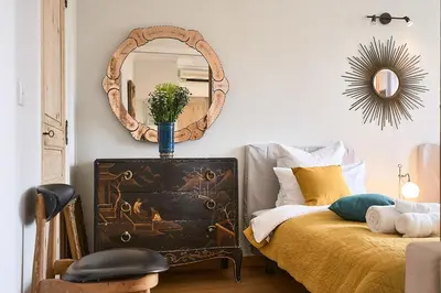 a bedroom with a bed and a mirror on the wall at Sunlight Properties - Marinette - Port area, 2 Bedrooms, sleep 6, sea view in Nice