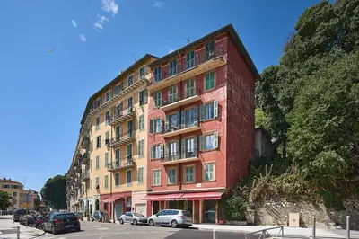 a tall red building with cars parked in front of it at Sunlight Properties - Marinette - Port area, 2 Bedrooms, sleep 6, sea view in Nice