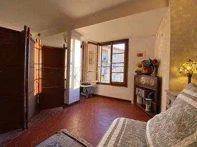 a living room with a bed and a window at CHARMANT HOME-Azur Charmant in Nice