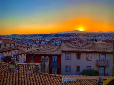 a sunset over a city with houses and roofs at CHARMANT HOME - Mariesol in Nice