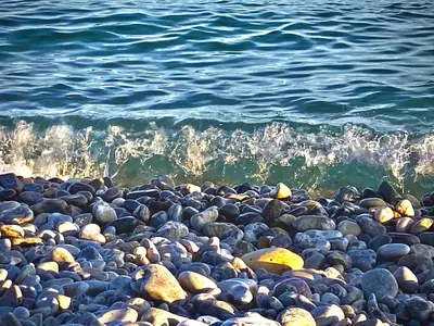 a pile of rocks on a beach near the water at CHARMANT HOME - Mariesol in Nice