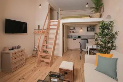a living room with a loft bed and a dining room at Charmant Studio climatisé - Vieux Nice in Nice