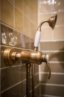 a shower head with a hose in a bathroom at Charmant Studio climatisé - Vieux Nice in Nice