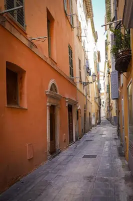 an empty street in an alley between buildings at Charmant Studio climatisé - Vieux Nice in Nice