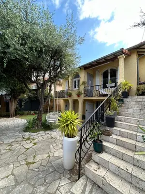 a house with stairs and potted plants at T2 RDJ sur la Côte d'Azur tout confort in Cagnes-sur-Mer