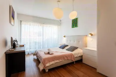 a bedroom with a large bed and a window at LE FRANCIA II AP4197 By RIVIERA HOLIDAY HOMES in Nice