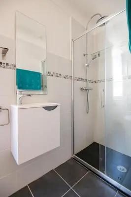 a bathroom with a shower with a glass door at 