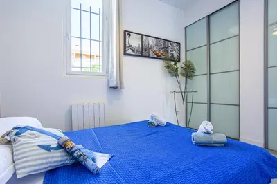 a bedroom with a blue bed with towels on it at MY CASA - GUISOL - Typical Nice 3 Bedroom AC near Port in Nice