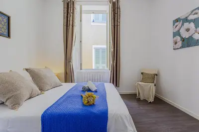 a bedroom with a bed with a blue blanket at MY CASA - GUISOL - Typical Nice 3 Bedroom AC near Port in Nice