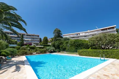 a swimming pool in front of a building at Sea View Park Swimming Pool & Tennis 2 Bdrs in Villefranche-sur-Mer