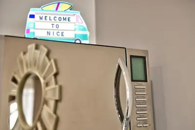 a microwave with a welcome to nice sign on top of it at Home Inn - Centre ville - Nice in Nice