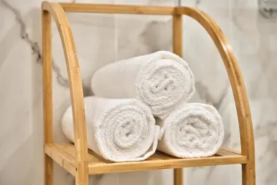 a bamboo towel rack with towels on it in a bathroom at Home Inn - Centre ville - Nice in Nice