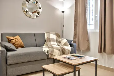 a living room with a couch and a table at Home Inn - Centre ville - Nice in Nice