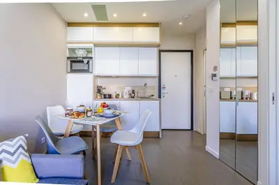 a kitchen and dining room with a table and chairs at MY CASA - GAMBETTA 33 - 5min walk to beach in Nice