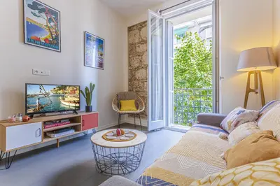 a living room with a couch and a tv at MY CASA - GAMBETTA 33 - 5min walk to beach in Nice
