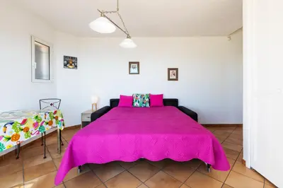 a large pink bed in a white room at Observatoire in Nice