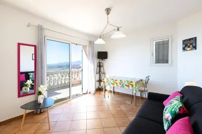 a living room with a couch and a balcony at Observatoire in Nice