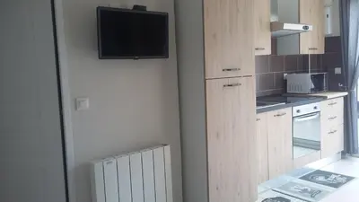 a kitchen with a flat screen tv on the wall at L'Ambre d'Or in Falicon