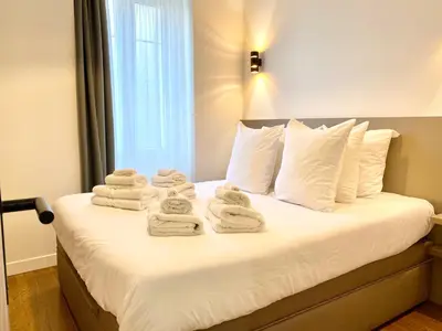 a bedroom with a bed with towels on it at Maxim - Easy Home Booking in Nice