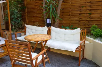 a table and two chairs and a table and a table at Auberge de Jeunesse HI Nice Les Camélias in Nice