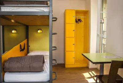 a room with a bunk bed and a desk at Auberge de Jeunesse HI Nice Les Camélias in Nice