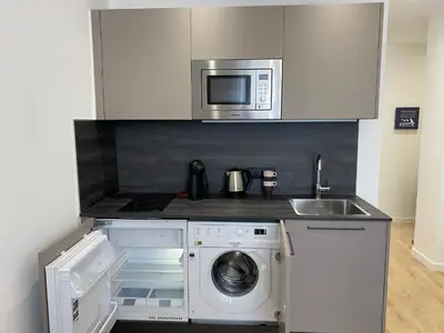 a kitchen with a washing machine and a microwave at JEAN MEDECIN - Modern and brand new 1Br flat in Nice