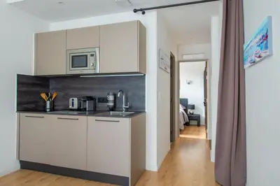 a kitchen with white cabinets and a microwave at JEAN MEDECIN - Modern and brand new 1Br flat in Nice