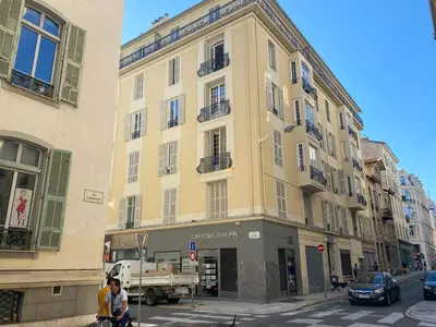 a large yellow building on a city street at JEAN MEDECIN - Modern and brand new 1Br flat in Nice