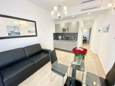 a living room with a couch and a glass table at JEAN MEDECIN - Modern and brand new 1Br flat in Nice