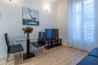 a living room with a glass table and a tv at JEAN MEDECIN - Modern and brand new 1Br flat in Nice