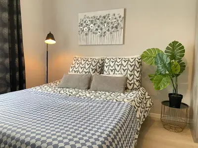 a bedroom with a blue and white bed with a plant at Nice Renting - BUFFA - Cosy Studio fully equipped - Beach & Negresco in Nice