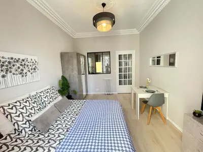 a bedroom with a large bed and a desk at Nice Renting - BUFFA - Cosy Studio fully equipped - Beach & Negresco in Nice