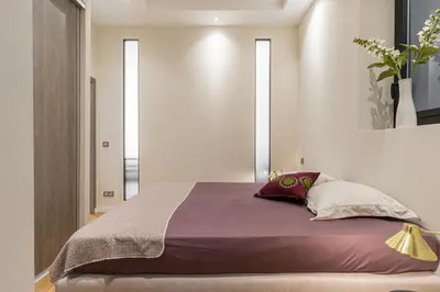 a bedroom with a bed with purple sheets and pillows at Cosy Cocoon Place du Pin in Nice