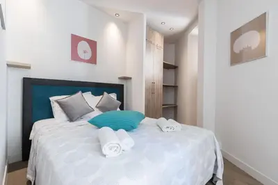 a bedroom with a white bed with towels on it at Refined & Cozy 1 Bedroom Downtown in Nice
