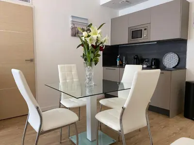 a dining room with a glass table and white chairs at LAMARTINE- Heart of Center- Modern and Design flat in Nice