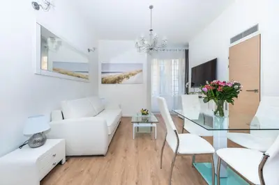 a living room with white furniture and a glass table at LAMARTINE- Heart of Center- Modern and Design flat in Nice