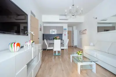 a living room with a white couch and a table at LAMARTINE- Heart of Center- Modern and Design flat in Nice