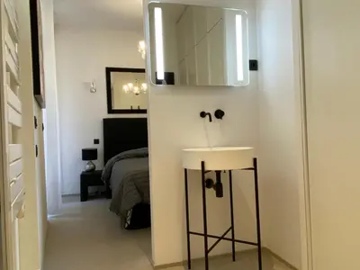 a bathroom with a sink and a bed in a room at ZEN and Charming - Center -5 min walk to Sea- 2BR in Nice