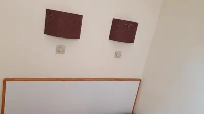 two switches on a wall next to a refrigerator at Appartement Ange Gardien Vue Mer in Villefranche-sur-Mer