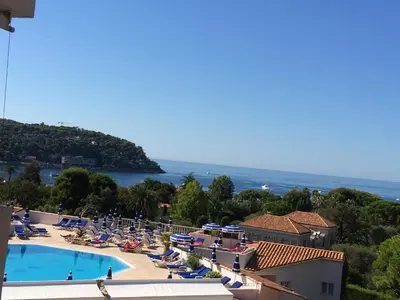 a view of a resort with a swimming pool at Appartement Ange Gardien Vue Mer in Villefranche-sur-Mer