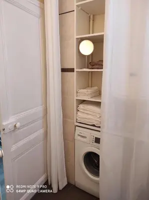 a laundry room with a washer and dryer next to a door at Pretty and quiet top floor 2 bedroom flat in the port area of Nice in Nice