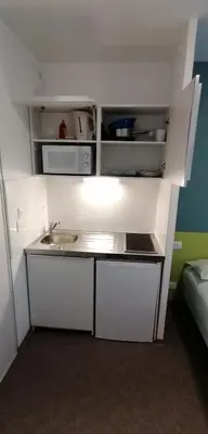 a small kitchen with a sink and a microwave at PARME ETAPE in Nice