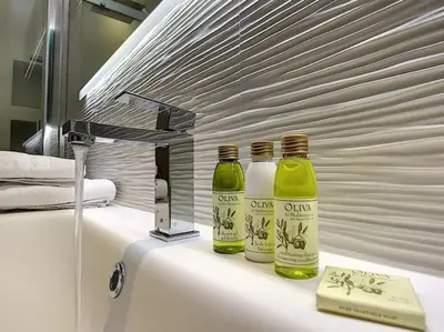 two bottles sitting on top of a bathroom sink at Silver Beach Central 4pers Séjour 30jours Location éligible au Bail Mobilité Mobility Lease in Nice