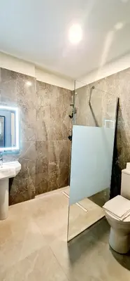 a bathroom with a shower and a toilet and a sink at Evelia Hotels in Nice