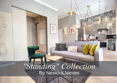 a living room with a couch and a kitchen at Nestor&Jeeves - VEGA GIOFFREDO - Hyper center - Close sea and Old Town in Nice