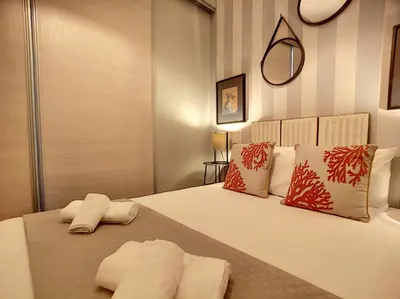 a bedroom with a bed with two towels on it at Nestor&Jeeves - VEGA GIOFFREDO - Hyper center - Close sea and Old Town in Nice