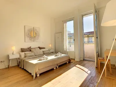 a bedroom with a large bed and a large window at Nestor&Jeeves - GLORIA BEACH - Very close sea - Prestigious building in Nice