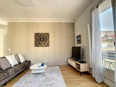 a living room with a couch and a tv at Nestor&Jeeves - GLORIA BEACH - Very close sea - Prestigious building in Nice