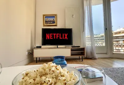 a living room with a television and a table with popcorn at Nestor&Jeeves - GLORIA BEACH - Very close sea - Prestigious building in Nice